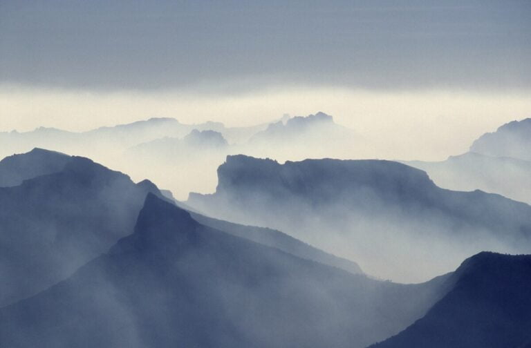 a mountain range with fog